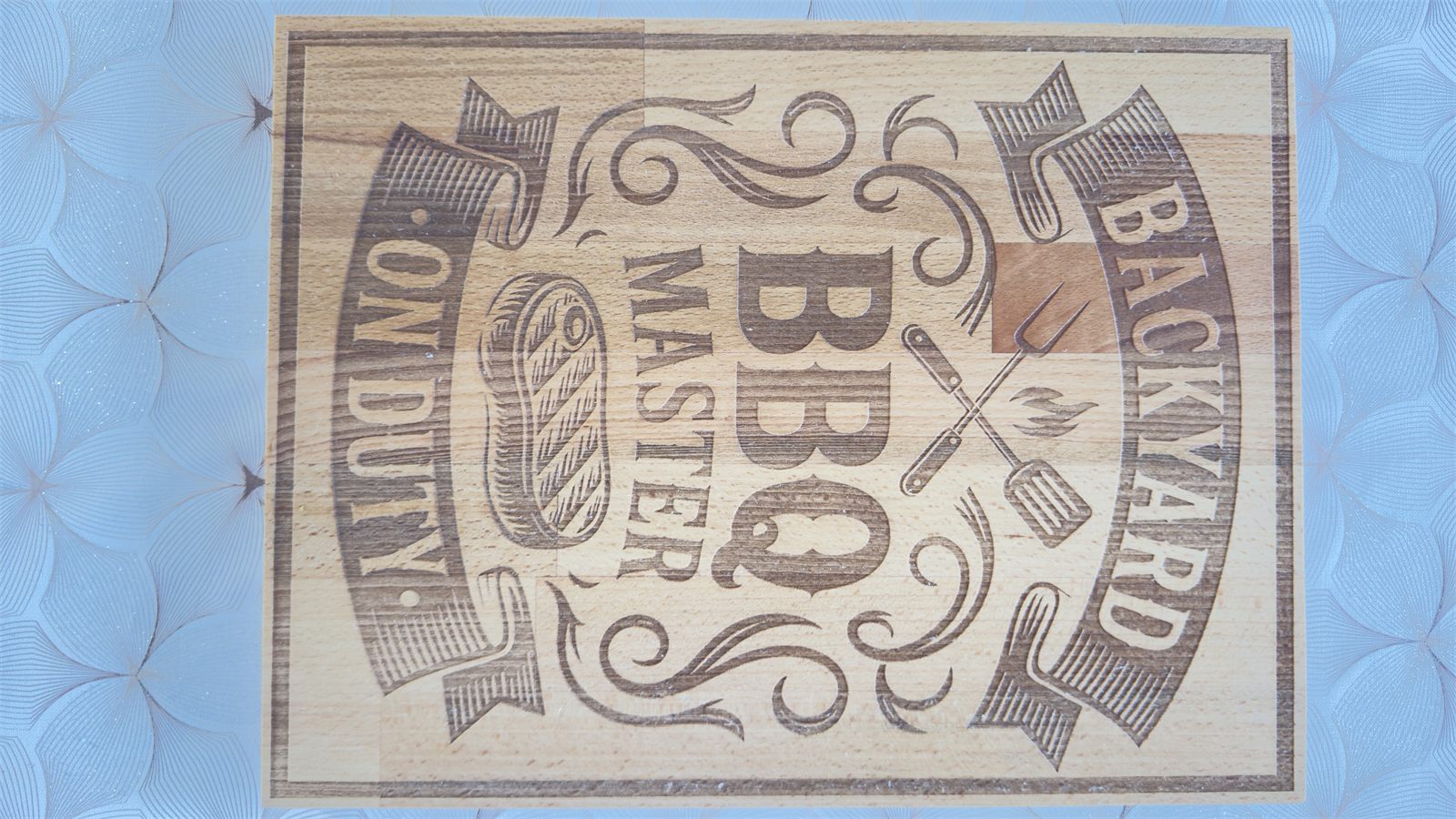 Wooden cutting board engraved with BBQ artwork
