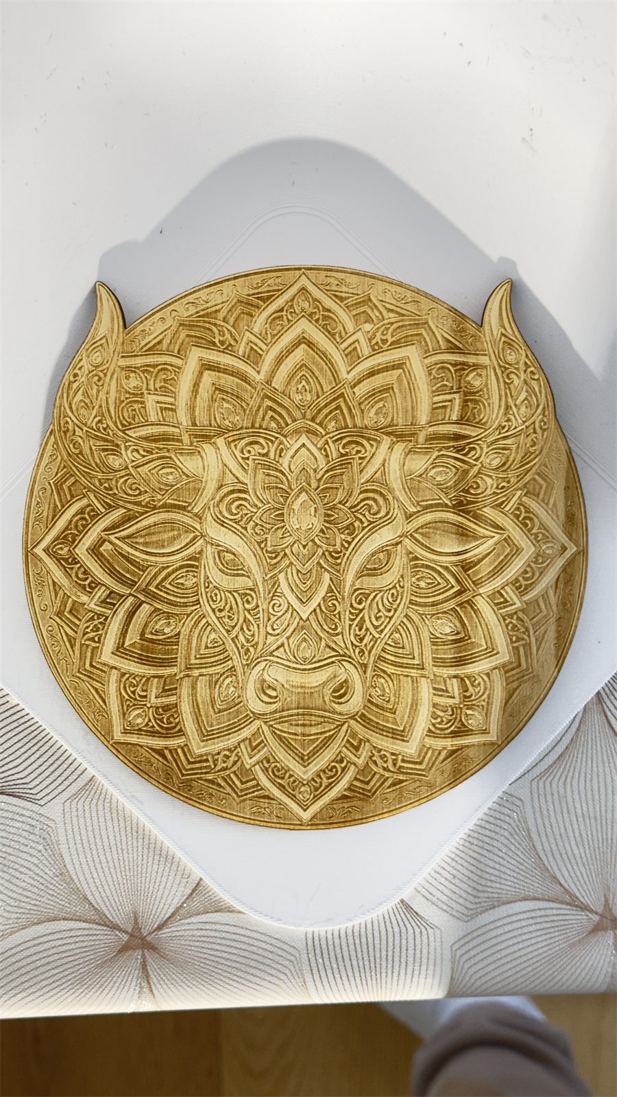 Wooden sign engraved with a mandala design