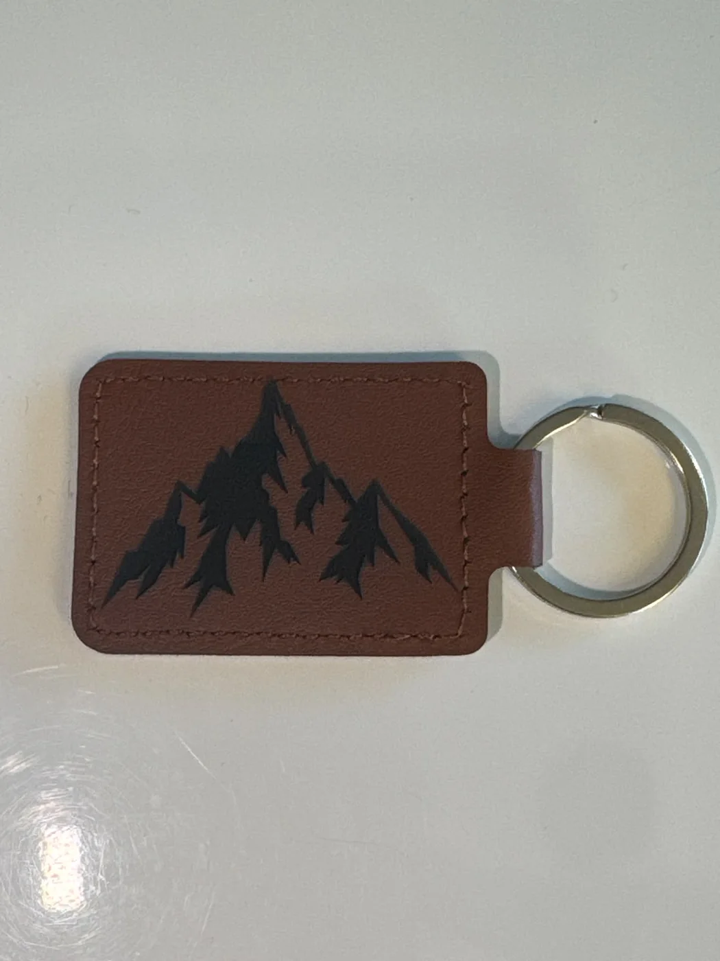 Brown PU leather keyring engraved with a mountain design