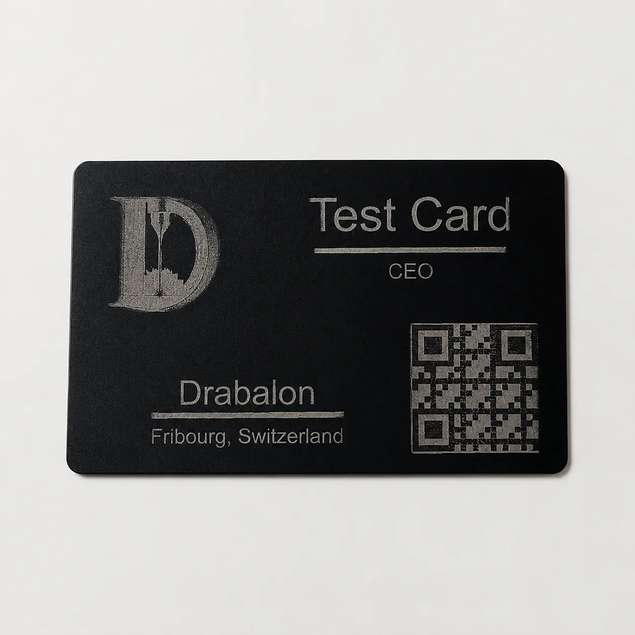 Black metal business card laser engraved with a logo, contact details and QR code